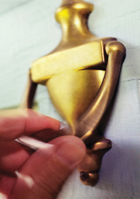 hand knocking on door knocker