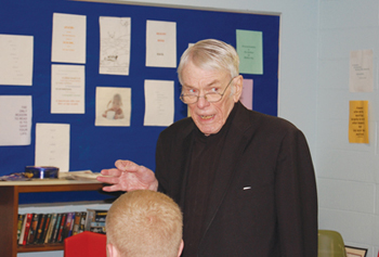 Father William J. O’Malley, S.J. teaching high school students