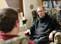 Father Subprior Guerric DeBona, O.S.B. of the Benedictine Archabbey of Saint Meinrad speaks with a visitor.