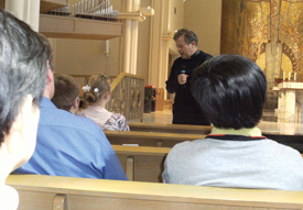 at a discernment retreat for both men and women sponsored by the Missionaries and Sisters of the Precious Blood, participants listen to Father James Seibert, C.PP.S. speak about the religious orders’ history.