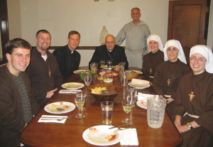 Cardinal Francis George, O.M.I., archbishop of Chicago, seated with the members of the Franciscans of the Eucharist. With men’s and women’s sections, this new religious community is part of the Mission of Our Lady of the Angels. Lombardo (standing) has served as an advisor to the young adults who founded the order.