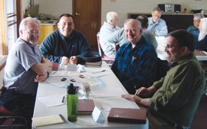 Friar Andy Martinez, O.F.M. Conv. (at end of table) talks with members of his community during a workshop: (from left) Conventual Franciscan Friars Vincent Petersen (whose artwork was featured in the VISION article “Inspired images,” available online), Valentine Jankowski, and John Stowe.