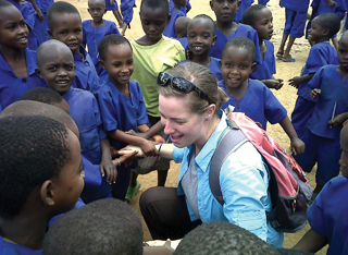 erin mcdonald greets children at a Congolese refugee camp.