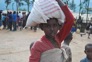 A girl receives food rations at the Congolese refugee camp where Erin McDonald worked as she considered religious life.