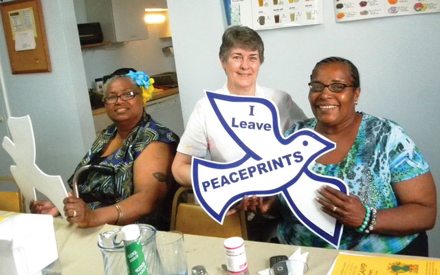 At a Women’s Empowerment Dinner, two attendees receive Peace Doves.