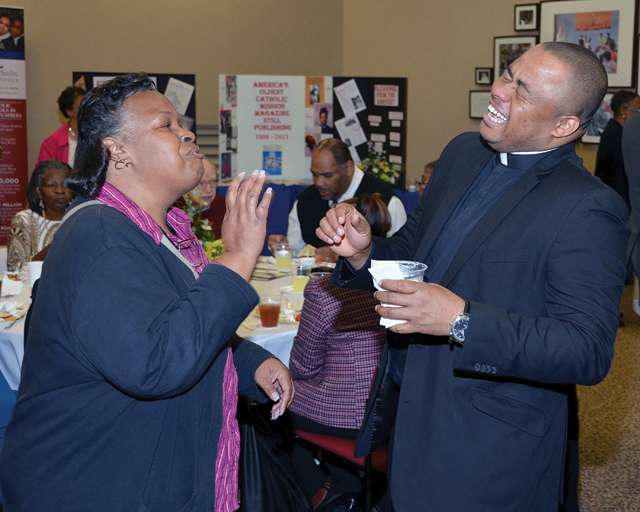Father Cornelius Ejiogu, S.S.J., pastor at St. Luke’s Catholic Church in Washington, D.C., enjoys a moment with a parishioner.