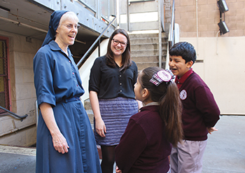 Powers and LaSallian volunteer Samatha Hyland share a laugh with students