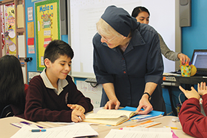 Sister Kathleen Powers, D.C. provides student support as an extra teacher in the classroom