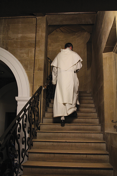 Gay walks up stairs in monastery