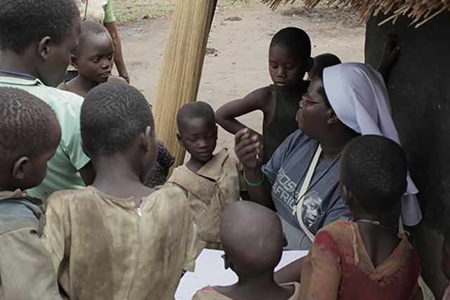 Sister Rosemary Nyirumbe, S.S.H.J. visits with children
