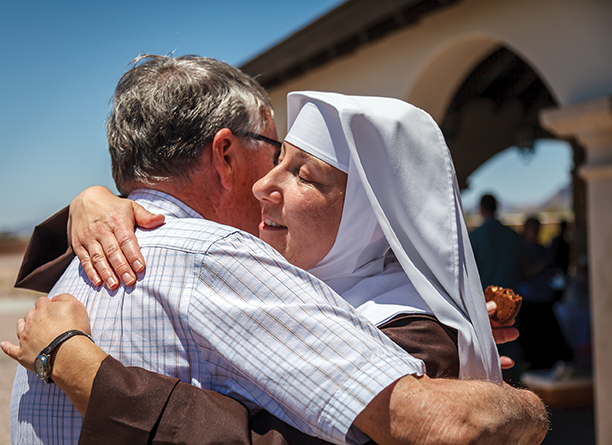 The new Sister Augusta Mary of Our Lady of Grace hugs a friend. 