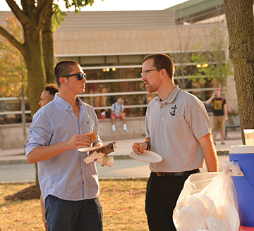 At “Pizza on the Plaza,” a campus ministry event at Rutgers State University, Jordan chats with a student. 