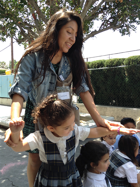 Laura Leon plays with children at Little Flower Educational Center in Los Angeles, 