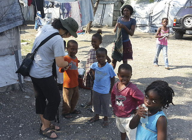 Lee with children during a service trip to Haiti that influenced her vocation decision.