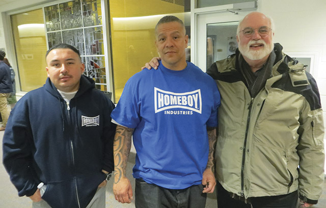 Jesuit priest Greg Boyle poses with Nicholas Lopez (left) and Luis Colocio of Homeboy Industries.