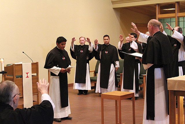 Brother Daniel Hernández, O.S.C. receives the blessing of his community after he puts on his habit for the first time. 