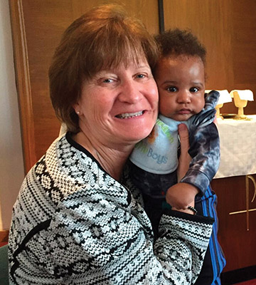 Sometimes holding a baby “makes my heart yearn,” writes Sister Terry Rickard, O.P., pictured here with a colleague’s child.