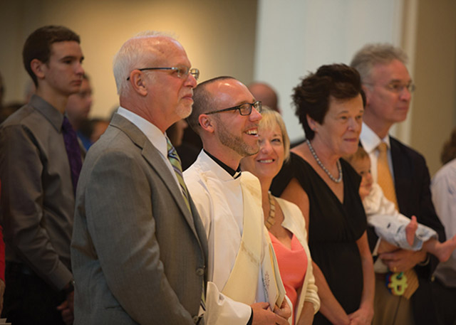 Gilger with his parents on either side of him at his ordination Mass. 