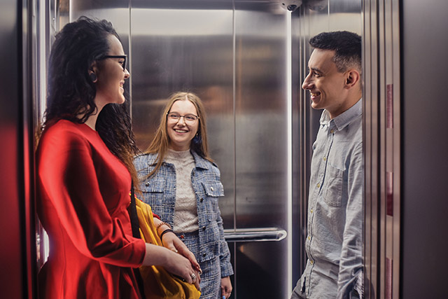 people chatting in an elevator