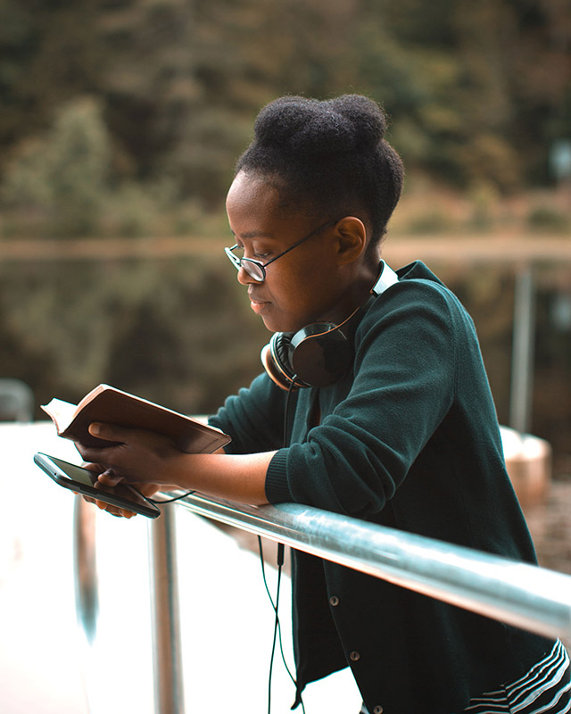 young woman praying with a Bible