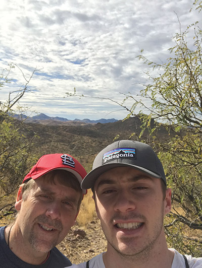 Father Corey Brost, C.S.V. (left) with a student pilgrim near the U.S.-Mexico border