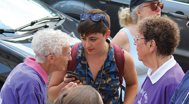 Sister JoAnn Persch, R.S.M. (left) and Sister Pat Murphy, R.S.M. (in purple shirts) are interviewed before taking part in a civil-disobedience action.