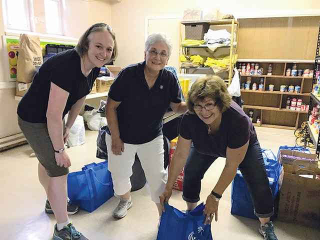 Sister Colleen Gibson, S.S.J. (left) works in the food pantry of the Sisters of St. Joseph Neighborhood Center in Camden, New Jersey.