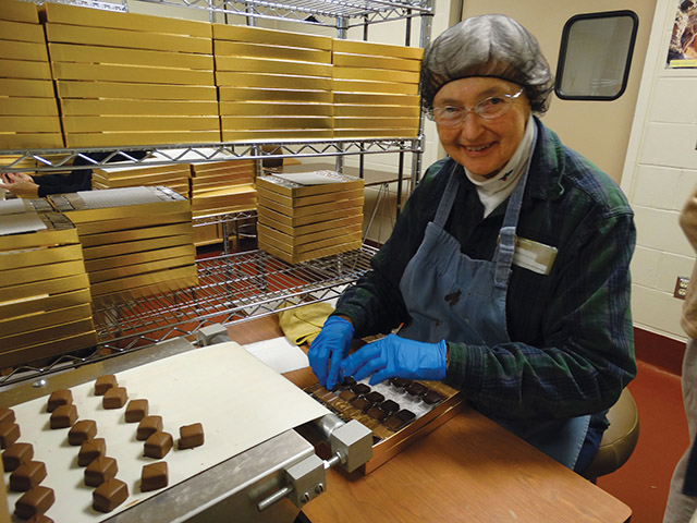 Sister Gail Fitzpatrick, O.C.S.O. works at candy-making.