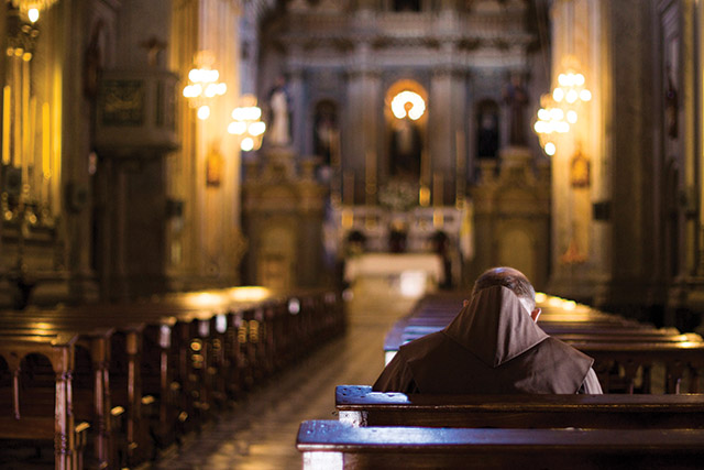 Brother praying in a church