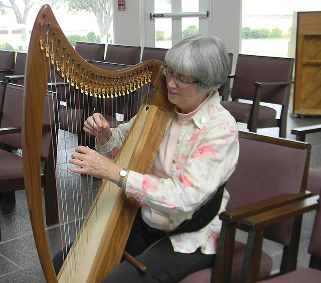 Sister Theresa Hoffman, O.S.B. plays the harp. 