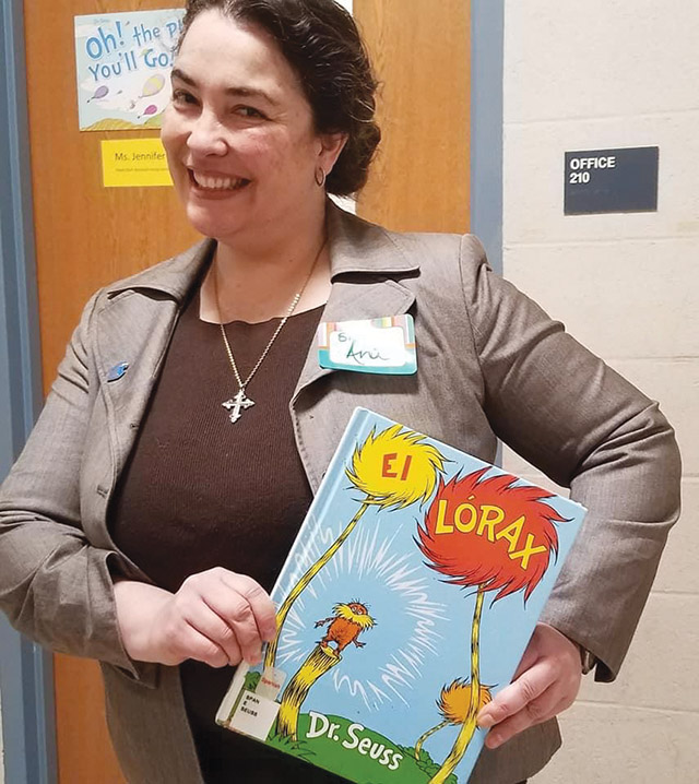 Sr. Gonzalez shows off a book she read to elementary school students as part of a National Reading Day celebration.
