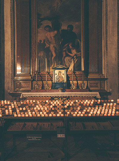 Catholic church altar with many lit candles