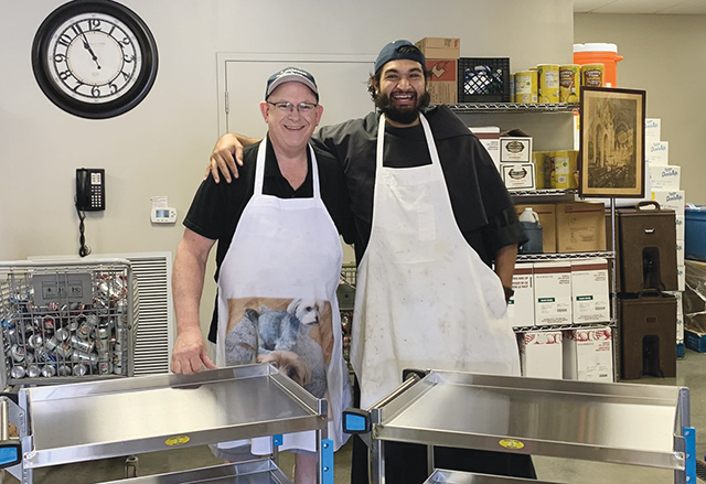 Some 400 meals per day are served with a smile at the Franciscan Kitchen in Louisville, Kentucky. Pictured here are Chuck Mattingly, executive director (left) and Brother Jaime Zaragoza, O.F.M.Conv. 