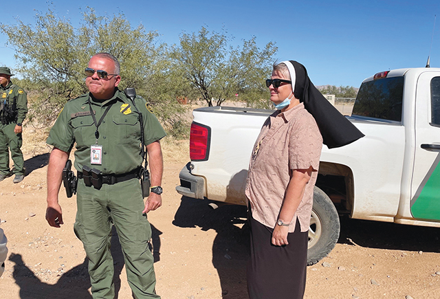 Felician Sister Maria Louise Edwards, C.S.S.F.   is at the Arizona border, in the Tohono O’odham Nation, with a border officer. 