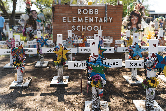 Robb Elementary school sign surrounded by grave markers