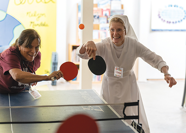 Sister Suzanne Miller, F.M.A. and volunteer Susan Trevino join the children’s games with a rousing round of Ping-Pong.