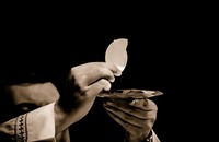 What do Catholics believe about the Eucharist? image