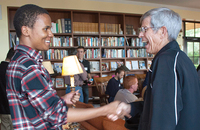 Lionell Daggs III greets Jesuit Father Stephen Privet, S.J. at an event at the University of San Francisco.