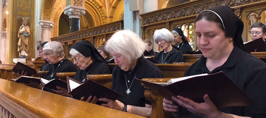  Sister Maria Victoria Cutaia, O.S.B. (far right), prays with her sisters. 
