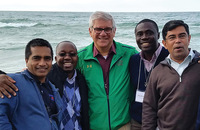 Brother Paul Bednarczyk, C.S.C. (center in green jacket) with other Holy Cross leaders at Lake Michigan.
