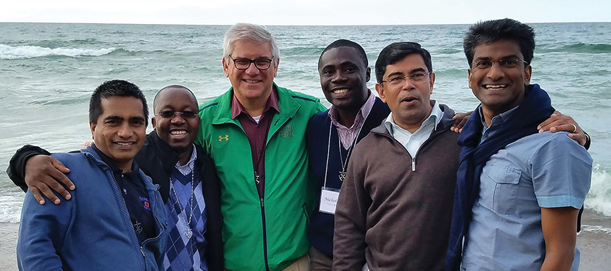 Brother Paul Bednarczyk, C.S.C. (center in green jacket) with other Holy Cross leaders at Lake Michigan.