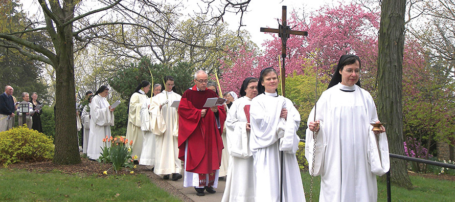 The nuns of Our Lady of the Mississippi Abbey, along with visitors who have joined them for Mass, celebrate Palm Sunday with an outdoor procession.