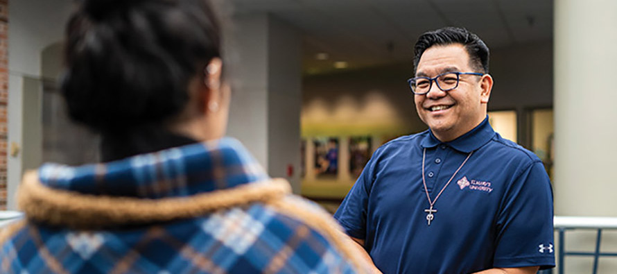 Brother Allen A. Pacquing, S.M. chats with a student at St. Mary’s University in San Antonio, Texas