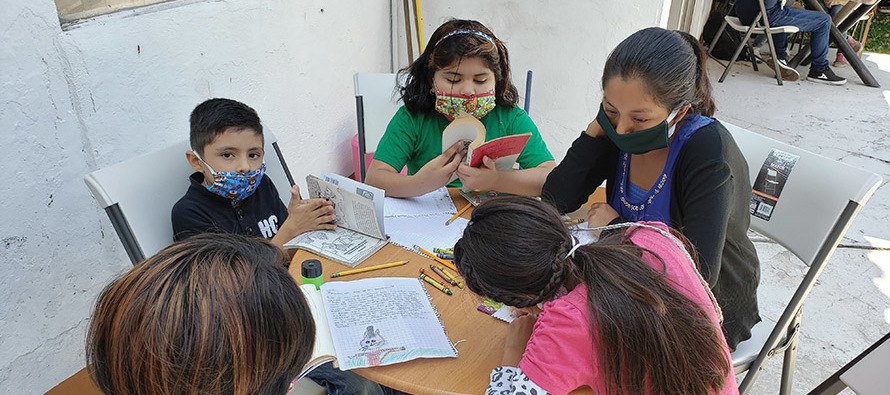 Alejandra Candia Tapia (top right) serves as a volunteer at Cuernavaca Children’s Mission , on this day helping children write book reports.