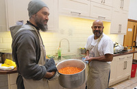 A Franciscan friar helps prepare a meal for the needy. 