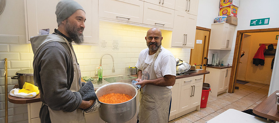 A Franciscan friar helps prepare a meal for the needy. 