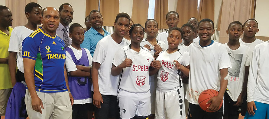 Father Honest Munishi, C.S.Sp. with youth during a basketball competition at St. Edward Parish in Baltimore.Father Honest Munishi, C.S.Sp. with youth during a basketball competition at St. Edward Parish in Baltimore.