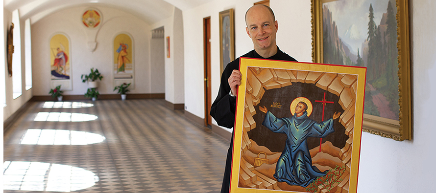 Father Michael Shrum, O.S.B. with the icon he created of Saint Benedict.