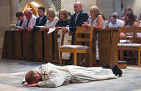 When a man is ordained, he lies prostrate on the floor as a symbol of giving over his entire life to service, as shown here in the Diocese of Rochester, New York.